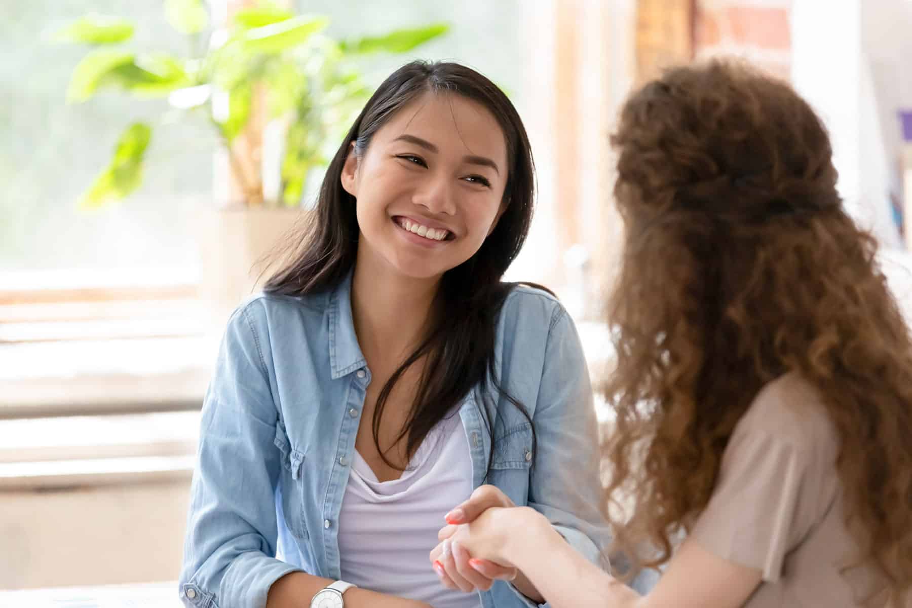 Young woman smiling and shaking hands